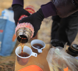 coffee from the thermos outdoors in cold weather