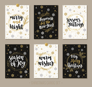 Set Christmas and Happy New Year greeting cards with handwritten brush calligraphy and decorative elements.
