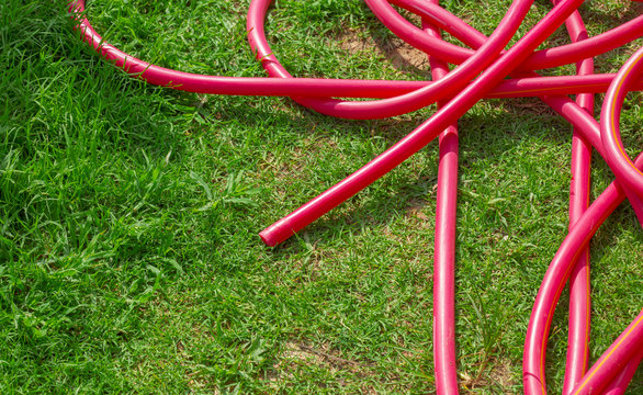 Red Hose, Messy Hose On Green Grass