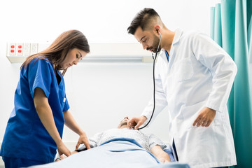 Doctor and nurse working on a patient
