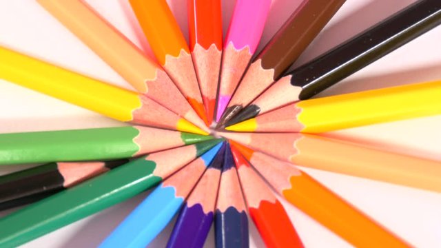 pencils of bright colors are removed one by one from circle and then put back on white surface, creativity, use imagination. Close up, stop motion, 4K Ultra HD.
