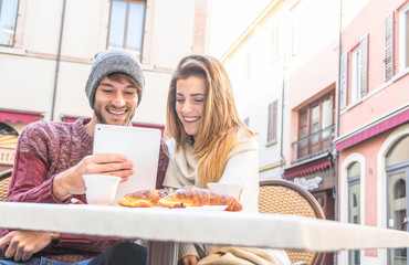 Young couple using digital tablet on a date at the bar.