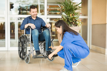 Nurse helping patient in a wheelchair