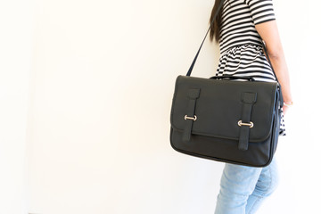 Woman carrying a black leather bag