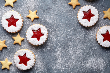 Linzer star cookies with jam filling decorations flat lay traditional winter Christmas homemade Austrian sweet dessert food Xmas celebration pastry holiday snack on vintage background.