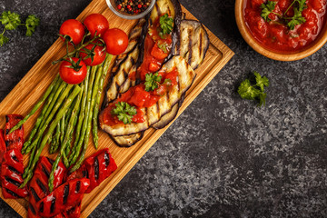 Grilled vegetables with tomato sauce and fresh herbs.