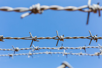fence with barbed wire with blue sky