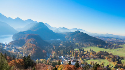 Mountain autumn landscape with colorful forest. Blue sky.