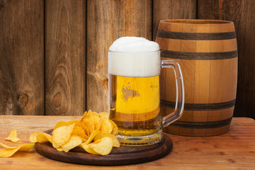 Beer and chips on wooden background