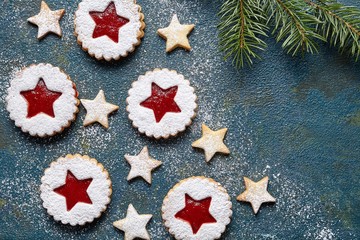 Christmas or New Year homemade cookies star with strawberry jam. Traditional Austrian dessert - Linzer biscuits. Flat lay. Festive decoration. Top view. Copy space.