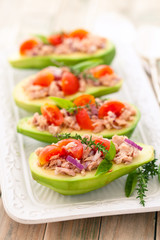 Stuffed avocado on tray.