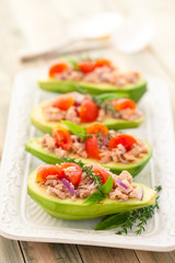 Stuffed avocado on tray.