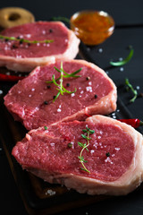 Raw steaks and spices
