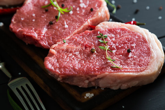 Raw steaks and spices