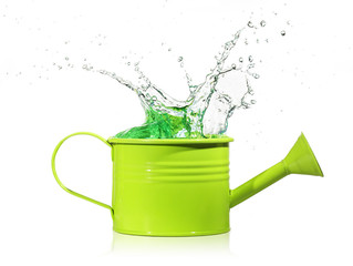 liquid splashing out from a green watering can