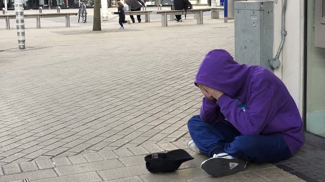 homeless asking charity at the corner: poor man, jobless, clochard