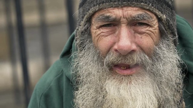 old homeless smoking: closeup portrait of a real homeless