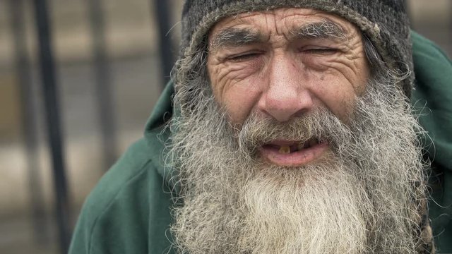 elderly man smoking: homeless ma smoking in the city, poor man smoking