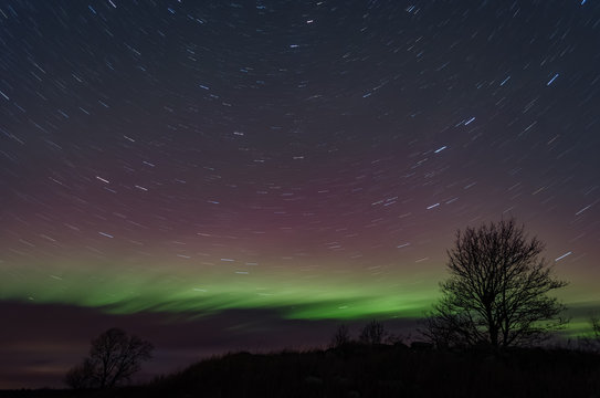 Northern lights (Aurora borealis) in the illuminated sky