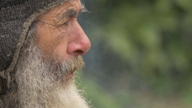 sad old man smoking in the city 
