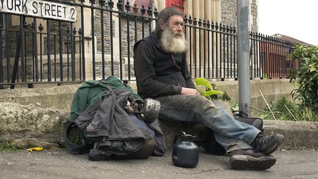 Homeless Person sitting in the street: old man, poor man, asking for food