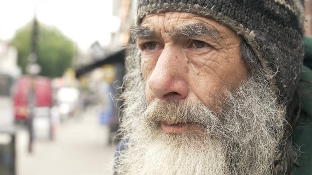 sad old man in the city: homeless looking in the street. poor man