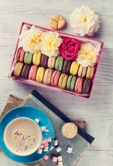 Colorful macaroons, coffee. Sweet macarons