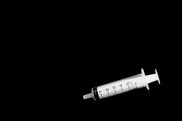 syringe on black background