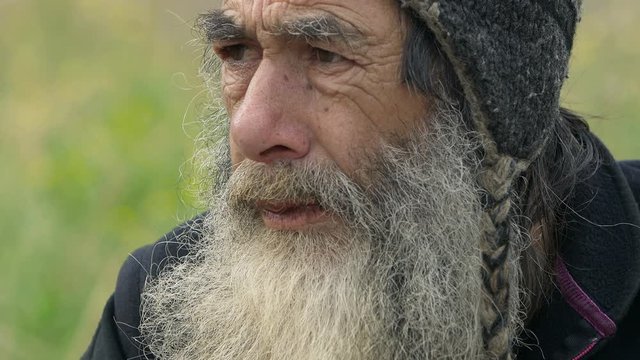 old homeless man living by charity 