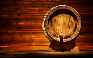 Wooden round barrel with old planks on background