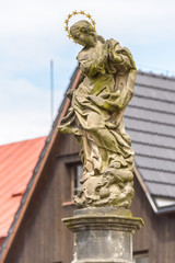 A statue of a woman with a halo over her head