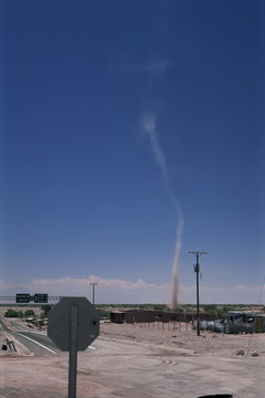 Mini twister (dust devil) forms above town, San Pedro de Atacama, Chile