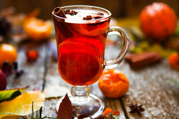 Mulled wine in mugs, spice and dry flowers and leaves. Autumn st
