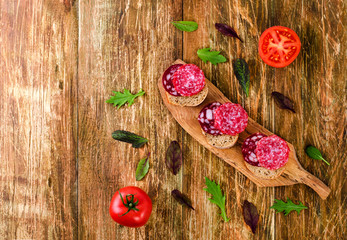Sandwiches sausage,herbs and tomatos.