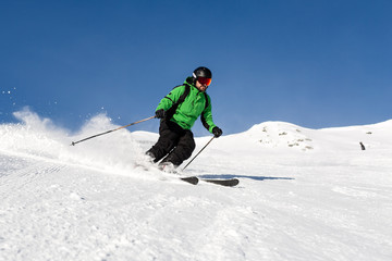 Fototapeta na wymiar Skier skiing on ski slope