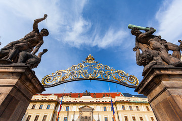 Obraz premium Entrance Gate of the Prague Castle, Czech Republic. Gates, two statues in the foreground and part of the palace in the background