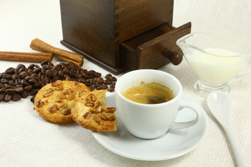 coffee beans grinder and hot cup of on white background