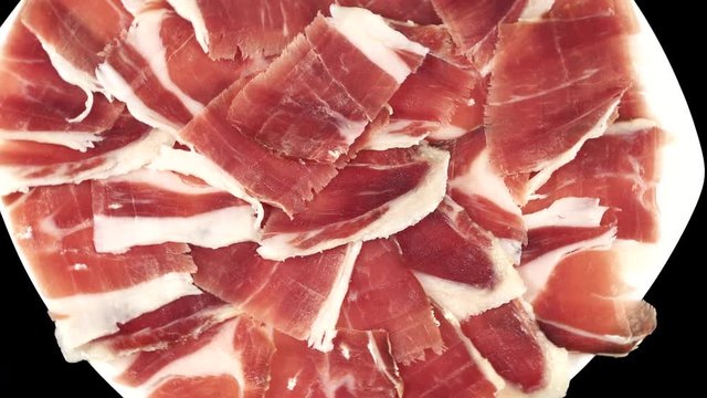Acorn ham plate rotating closeup, top view, black background