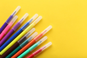Felt-tip pens on a yellow background