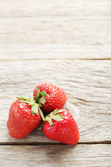 Fresh and tasty strawberries on a grey wooden table