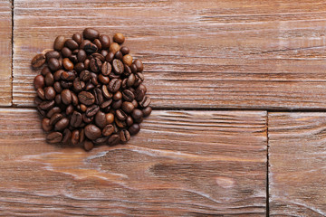 Roasted coffee beans on a brown wooden table