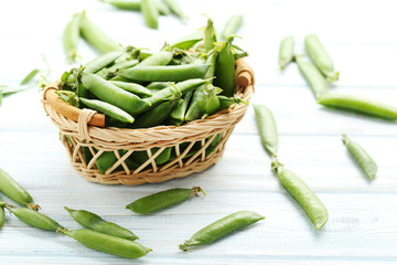 Green peas on a blue wooden table