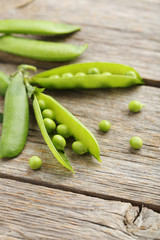 Green peas on a grey wooden table