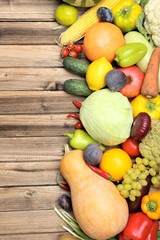 Ripe fruits and vegetables on wooden table