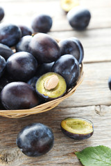 Tasty and ripe plums on grey wooden table