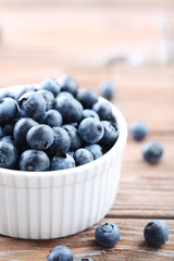Ripe and tasty blueberries on brown wooden table