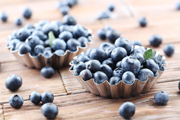 Ripe and tasty blueberries on brown wooden table