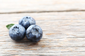 Ripe and tasty blueberries on grey wooden table