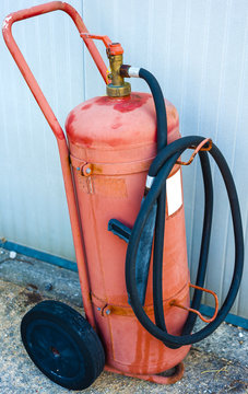 old fire extinguisher on wheels in poor condition