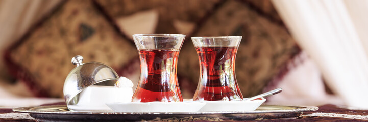 Two turkish tea cups and turkish delight with oriental canopy be